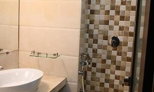 a bathroom with a sink and a shower at FabHotel Prime Ace Grand in Vadodara