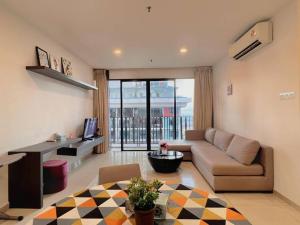 a living room with a couch and a table at 2 BR & 2 BTH with Free Parking @ Near ThemePark, SnowWalk & Central I-City Mall in Shah Alam