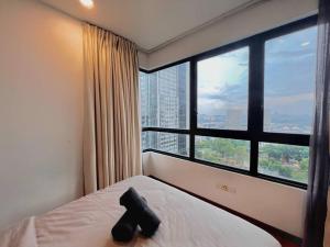 a room with a bed with a large window at 2 BR & 2 BTH with Free Parking @ Near ThemePark, SnowWalk & Central I-City Mall in Shah Alam