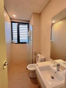 a bathroom with a white toilet and a sink at 2 BR & 2 BTH with Free Parking @ Near ThemePark, SnowWalk & Central I-City Mall in Shah Alam +12 photos