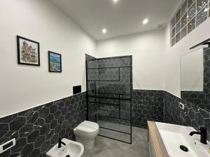a bathroom with a toilet and a sink at Palermo Wow - Aragona in Palermo