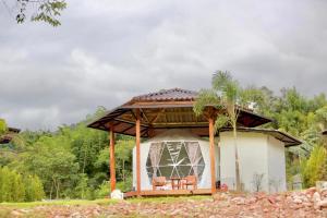a gazebo with a table and chairs in it at ริมว้าริว่า แคมป์ Rimwa Riwa Camp บ่อเกลือ น่าน in Ban Huai Mi