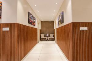 a hallway of a hospital with wooden panels and chairs at Hotel Florida -Manali Highway & 9 mins drive from Chandigarh University in Kharar +29 photos
