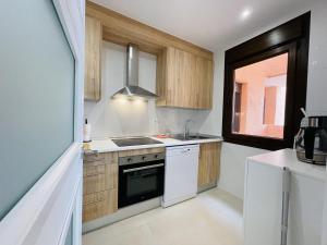 a kitchen with a sink and a stove at Casa Michella - Golf and Seaview & Pet-Friendly in Los Alcázares