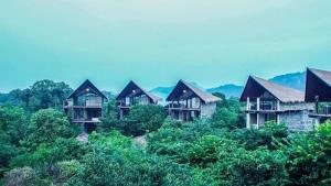 a row of houses on a hill with trees at Aswadduma Hotel in Dambulla