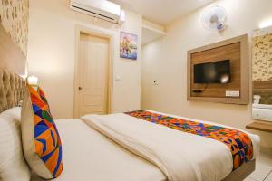 a bedroom with a bed and a tv on the wall at Hotel Florida -Manali Highway & 9 mins drive from Chandigarh University in Kharar
