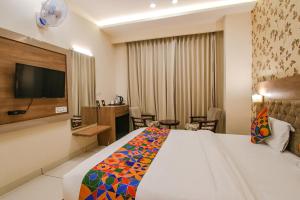 a hotel room with a bed and a flat screen tv at Hotel Florida -Manali Highway & 9 mins drive from Chandigarh University in Kharar
