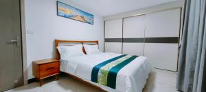 Postel nebo postele na pokoji v ubytování Ocean Breeze Apartment