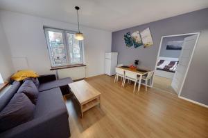 a living room with a couch and a table at Crystal Apartment Katowice VI in Katowice