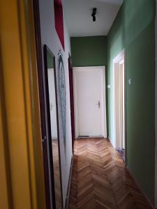 a room with green walls and a white door at Prishtina Center Hostel in Prishtinë