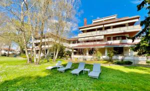 a group of chairs in front of a building at Hotel Bella Venezia in Latisana