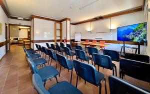 a conference room with blue chairs and a table at Hotel Bella Venezia in Latisana