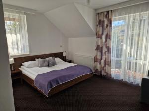 a bedroom with a bed and a large window at Willa Miła in Wisła +45 photos