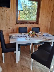 a table in a room with chairs and a window at Relaksówka 