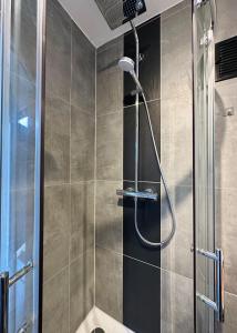 a shower with a shower head in a bathroom at Ferienhaus Ella in Trautskirchen +33 photos