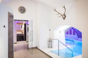 a bathroom with a swimming pool in a house at Schlosshotel Mondsee in Mondsee