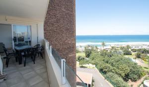a balcony with a table and a view of the ocean at 72 Sea Lodge Umhlanga Rocks in Durban