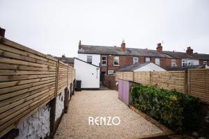 a fence with the words rishio on the side of a house at Spacious 3-bed Home in Lincoln by Renzo, Stunning Design, Close to Lincoln Cathedral! in Lincolnshire