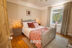 a bedroom with a bed and a window at Vibrant 3-bed Home in Lincoln by Renzo, Stunning Design, Close to Lincoln Cathedral! in Lincolnshire