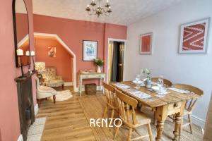 a dining room with a table and a living room at Vibrant 3-bed Home in Lincoln by Renzo, Stunning Design, Close to Lincoln Cathedral! in Lincolnshire