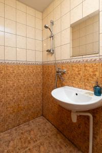 a bathroom with a sink and a mirror at Balvi Hotel in Balvi