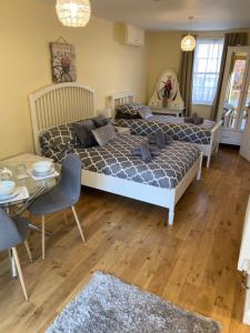 a bedroom with a bed and a table and a couch at The Ashton Gate Mews in Bristol