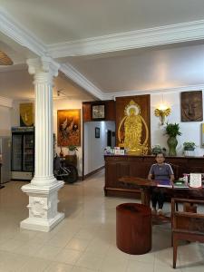 a little boy sitting on a table in a lobby at Mano boutique sun shine in Luang Prabang