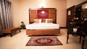 ein Schlafzimmer mit einem großen Bett in einem Zimmer in der Unterkunft Orchid Inn by WI Hotels in Karatschi