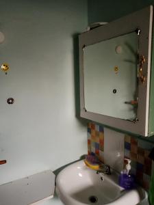 a bathroom with a sink and a mirror at Black gate in Nanyuki