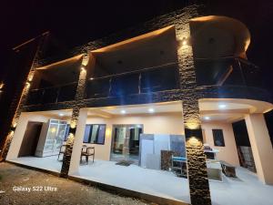 a house with a lit up facade at night at BULA VIP LOUNGE in Suva