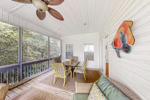a living room with a couch and a table on a balcony at A Shore Pleasure in Myrtle Beach