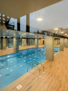 a large swimming pool in a large building at Bakuriani Crystal Loft in Bakuriani