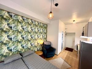 a living room with a couch and a wall at Savi Apartment 5 in Pärnu