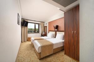 a hotel room with a bed and a window at Elan Hotel Istanbul Pera in Istanbul