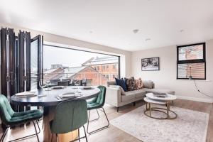 a living room with a table and chairs and a couch at Aire Apartments (Central) - Executive City Center Apartments in Leeds