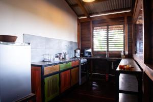 a kitchen with colorful cabinets and a refrigerator at Banana Moon in Ambatoloaka