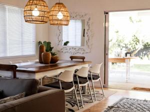 a living room with a bar and chairs at The Beach Bungalow in Hermanus
