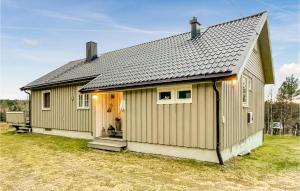 a small house with a gray roof at Cozy Home In stby With House A Panoramic View in Trysil