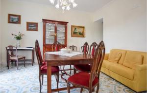 a dining room with a table and a couch at Cozy Home In Giungano With Wi-fi in Giungano