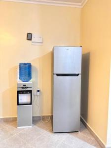 a white refrigerator and an oven in a room at Exquisite two bedroom Penthouse-Fully Furnished in Kitale