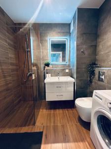a bathroom with a shower and a toilet and a sink at Apartament Stary Szczecin in Szczecin