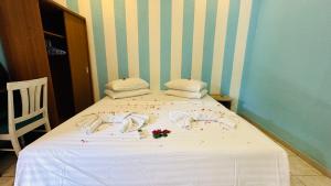 a white bed with a flower arrangement on it at Midsummer Thulusdhoo in Thulusdhoo