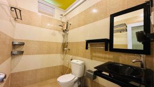 a bathroom with a sink and a toilet and a mirror at Midsummer Thulusdhoo in Thulusdhoo
