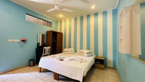 a bedroom with a bed with white sheets and pillows at Midsummer Thulusdhoo in Thulusdhoo