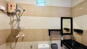 a bathroom with a shower and a toilet and a sink at Midsummer Thulusdhoo in Thulusdhoo