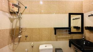 a bathroom with a shower and a toilet and a sink at Midsummer Thulusdhoo in Thulusdhoo