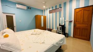 a bedroom with a bed with flowers on it at Midsummer Thulusdhoo in Thulusdhoo