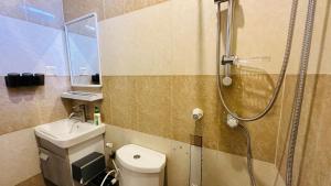 a bathroom with a shower and a toilet and a sink at Midsummer Thulusdhoo in Thulusdhoo