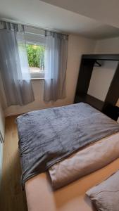 a large bed in a room with a window at Unterkunft Sanic in Kronberg im Taunus