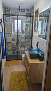 a bathroom with a blue sink and a shower at Casa Vacanza San Piero in San Piero in Campo